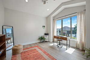 Office featuring vaulted ceiling, ceiling fan, and light hardwood / wood-style floors