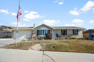 Ranch-style house with a front yard and a garage