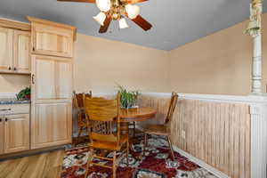 Dining area with hardwood / wood-style flooring and ceiling fan