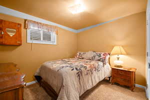 Bedroom with light colored carpet