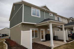 Rear view of house featuring a patio