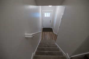 Stairs featuring hardwood / wood-style floors