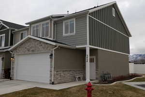 View of front facade featuring a mountain view and a garage