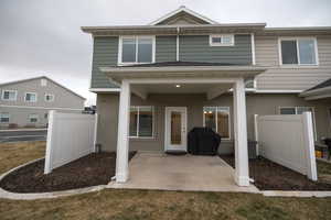 Back of property with a patio and central AC