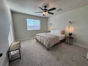 Carpeted bedroom with a textured ceiling and ceiling fan