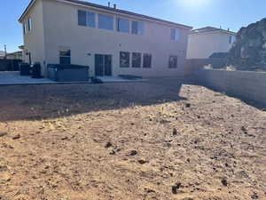 Rear view of house featuring a patio area and a hot tub