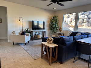 Living room featuring ceiling fan and light tile patterned flooring