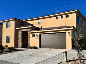 View of front of home with a garage and a mountain view