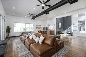 Living room with ceiling fan and hardwood / wood-style flooring