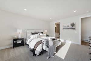 Bedroom with ensuite bathroom and carpet floors