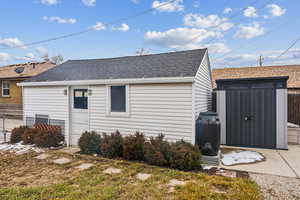 Back of house featuring a storage shed