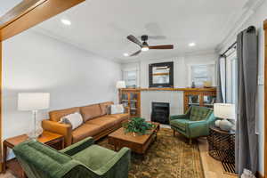 Family room with ceiling fan, hardwood / wood-style floors, and ornamental molding