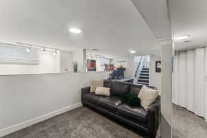 Bedroom featuring carpet and rail lighting