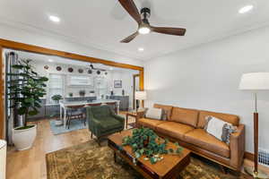 Family room with light hardwood / wood-style flooring and ornamental molding