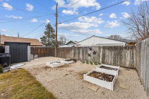 View of yard featuring a patio area and planter boxes.