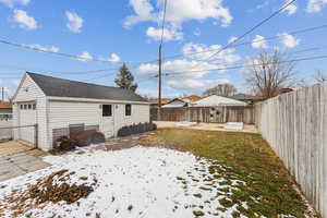 Snowy yard featuring a one-car garage