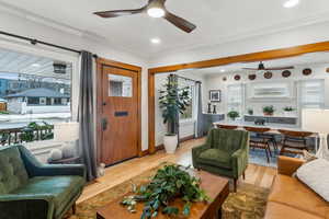 Family room featuring crown molding and light hardwood / wood-style flooring