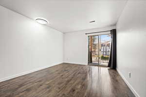 Spare room featuring dark hardwood / wood-style floors