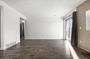 Unfurnished room featuring dark hardwood / wood-style flooring