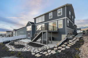 Rear view of house featuring a patio & deck