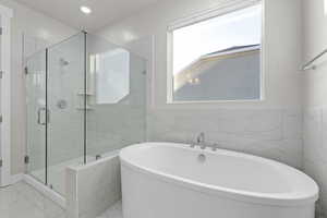 Primary bathroom with large soaker tub and separate walk in shower