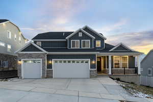 Craftsman-style home with a porch and a garage