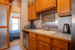 Kitchen featuring dishwasher and sink view to 2nd bedroom