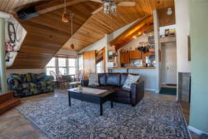 Living room view to kitchen, 2nd bedroom, and door to entrance