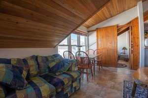 Living room featuring lofted ceiling and wooden ceiling