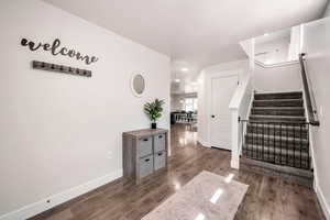 Stairway featuring hardwood / wood-style floors