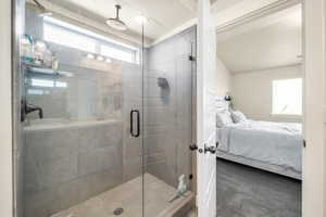 Bathroom featuring a textured ceiling and a shower with door