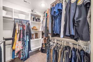 Spacious closet featuring carpet floors