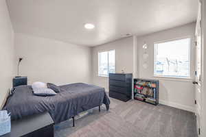 Bedroom featuring a textured ceiling and carpet