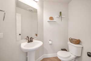 Bathroom featuring toilet and hardwood / wood-style floors