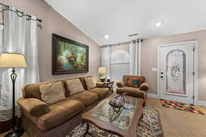 Tiled living room with lofted ceiling