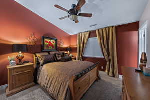 Bedroom with carpet, vaulted ceiling, and ceiling fan