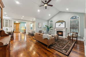 Living room featuring gas fireplace, high vaulted ceiling and cieling fan