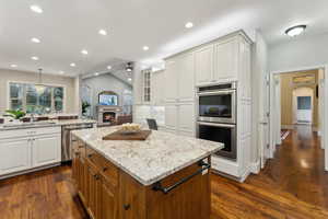 Kitchen featuring stainless steel appliances, white cabinetry, and double oven