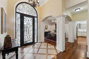 Large front entryway featuring beautiful tile floor and decorative columns