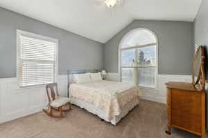 Carpeted bedroom featuring multiple windows, ceiling fan, vaulted ceiling, a closet and a view of the valley