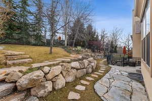 View of back yard featuring stone walk way