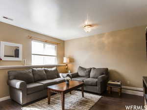 Living room with dark hardwood / wood-style floors