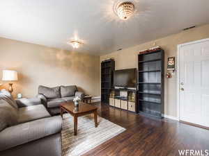 Living room featuring a chandelier and dark hardwood / wood-style floors