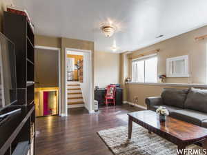 Living room with dark hardwood / wood-style flooring