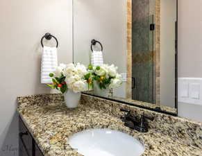 Bathroom with a shower with door and vanity