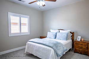 Bedroom with light carpet and ceiling fan