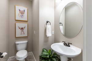 Bathroom with sink, tile patterned floors, and toilet