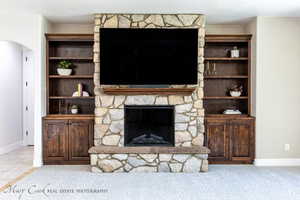 Carpeted living room featuring a fireplace