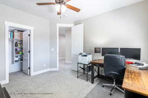 Carpeted office space with ceiling fan