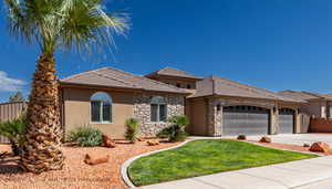 View of front facade featuring a front yard and a garage